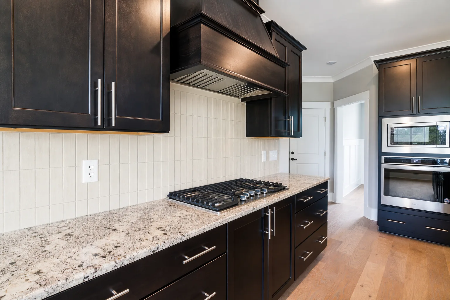 Quiet vertical tile backsplash preview with a busy granite countertop