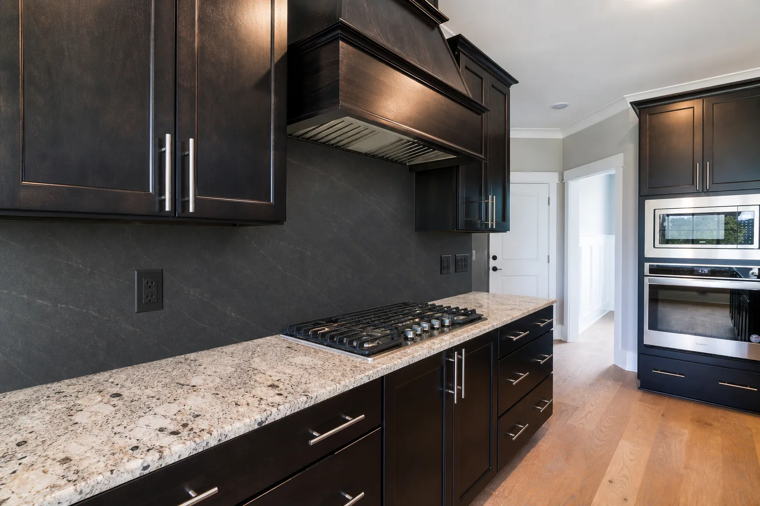 Black slab backsplash preview with dark kitchen cabinets