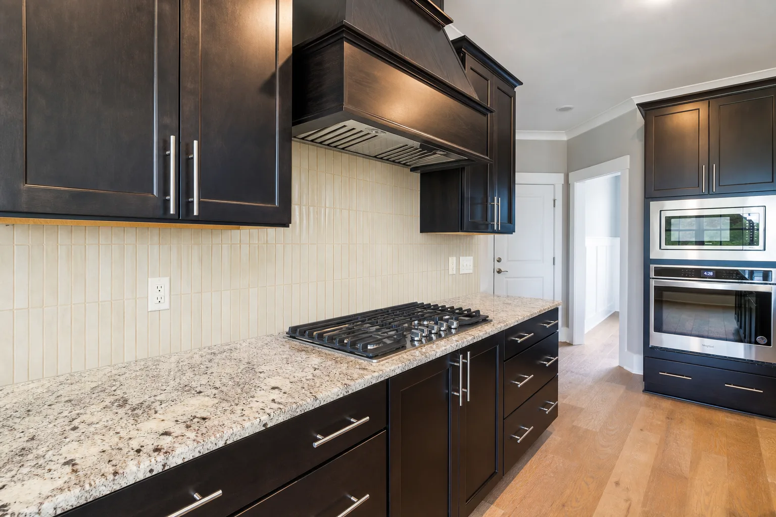 Ivory vertical tile backsplash preview with dark wood kitchen cabinets